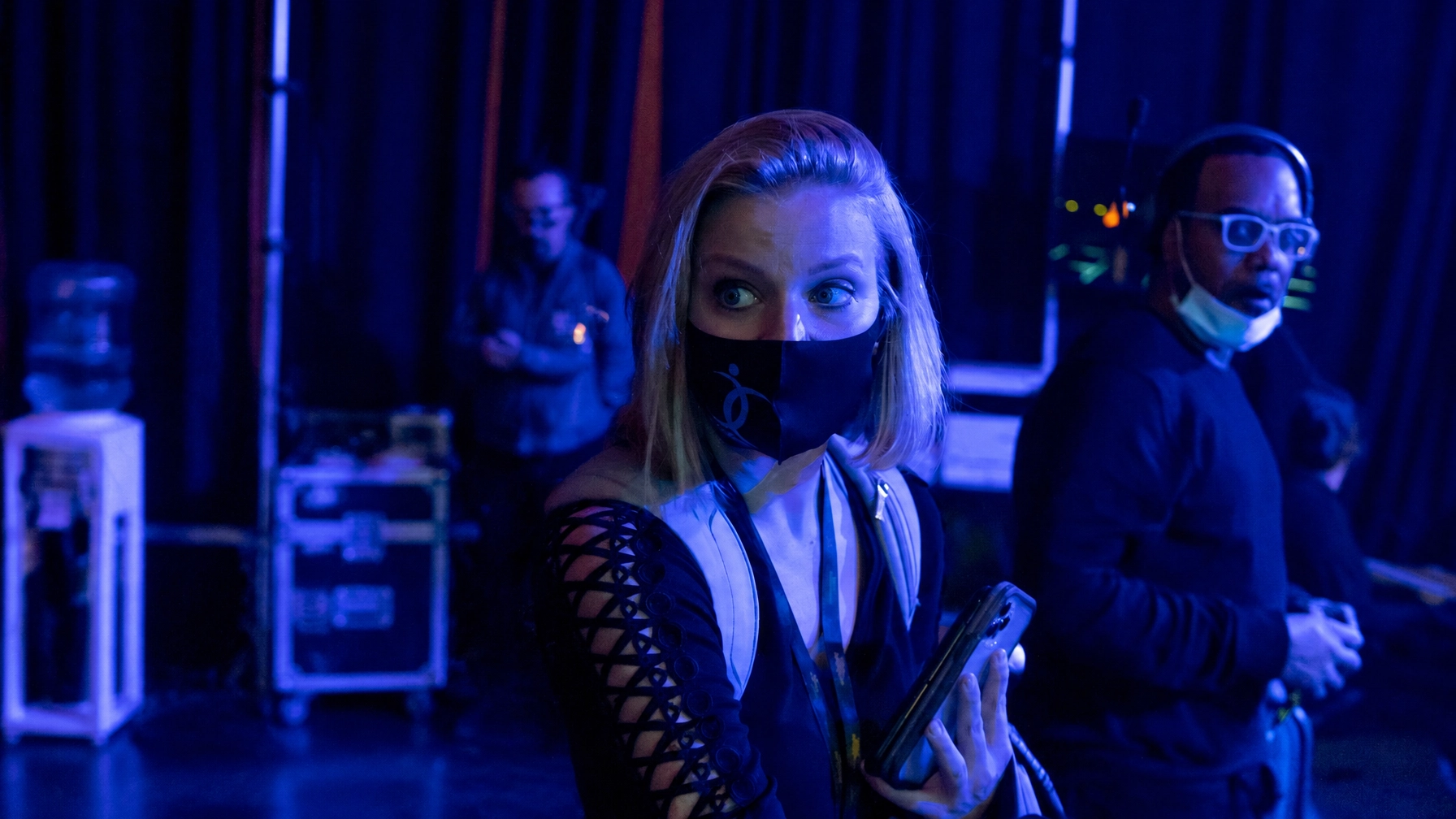 Susan and a colleague backstage in blue light
